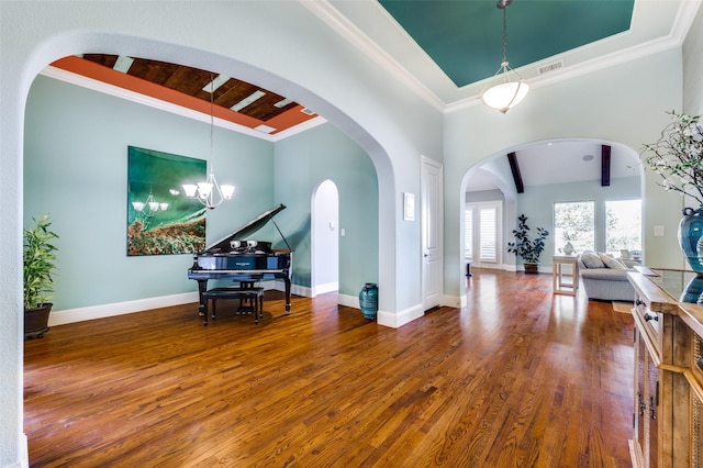 foyer featuring crown molding, hardwood / wood-style floors, and a notable chandelier