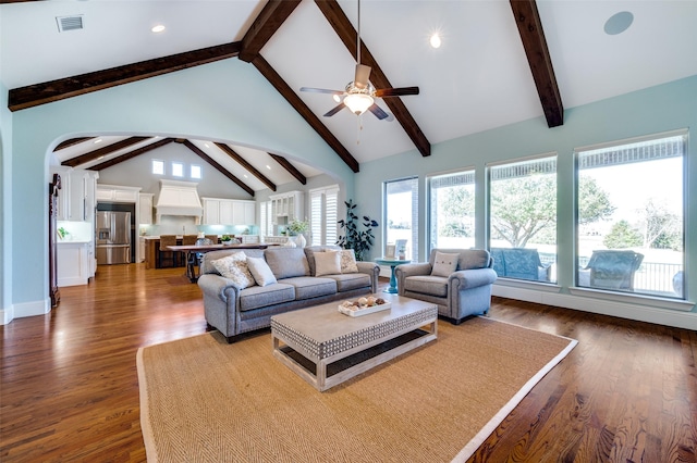 living room with beam ceiling, wood-type flooring, high vaulted ceiling, and ceiling fan