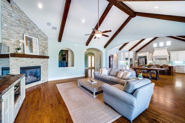 living room featuring beam ceiling, a stone fireplace, high vaulted ceiling, and dark hardwood / wood-style flooring