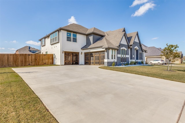 view of front of property with a garage and a front yard