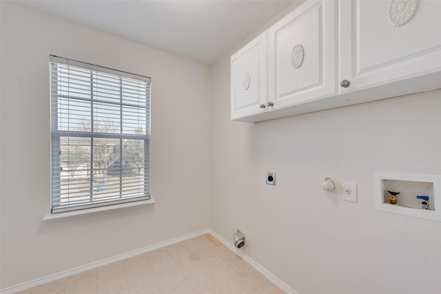 clothes washing area featuring cabinets, hookup for a gas dryer, hookup for a washing machine, and electric dryer hookup