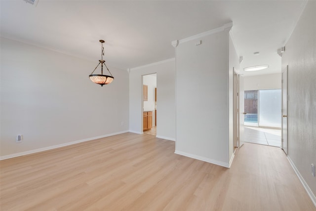 spare room with crown molding and light hardwood / wood-style floors