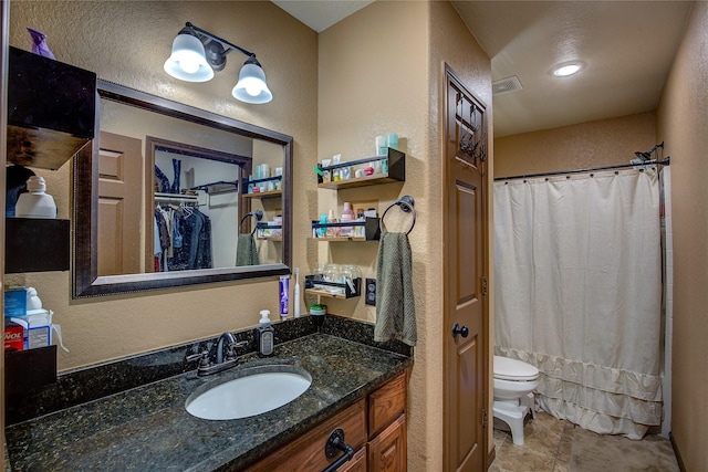 bathroom with vanity, tile patterned flooring, and toilet