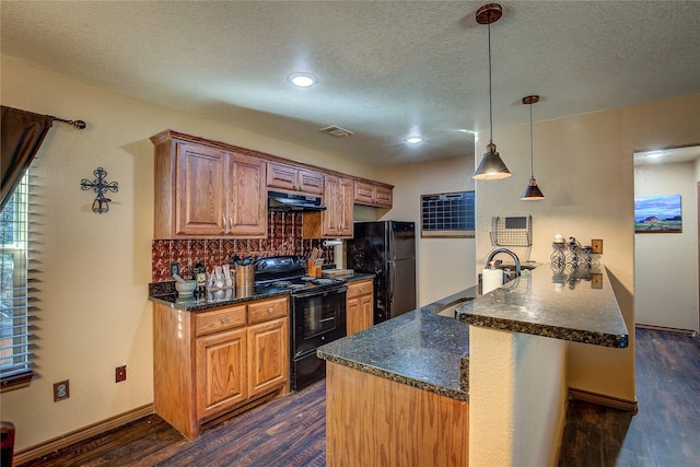 kitchen featuring sink, black appliances, dark hardwood / wood-style flooring, decorative light fixtures, and kitchen peninsula