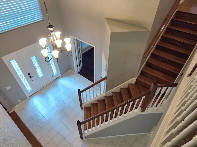6464 Richmond Dr, Frisco, TX 75035 - tiled foyer featuring stairs, a towering ceiling, a chandelier, and baseboards
