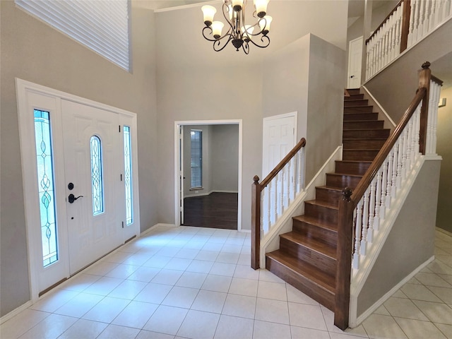 6464 Richmond Dr, Frisco, TX 75035 - foyer featuring a chandelier, stairs, light tile patterned floors, a towering ceiling, and baseboards