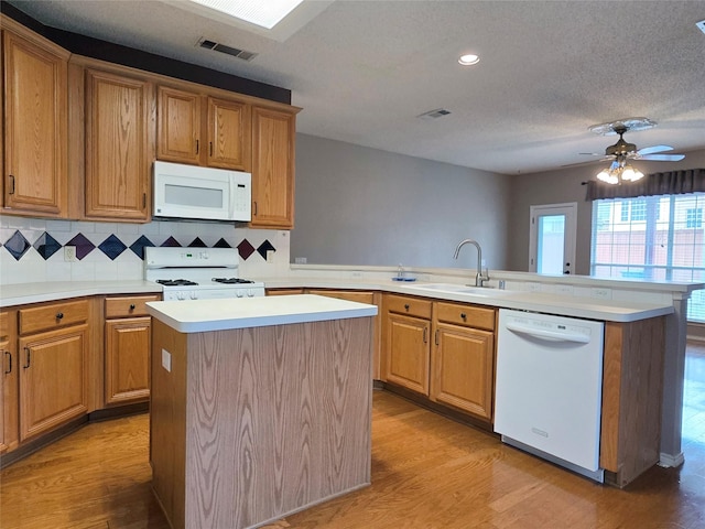 6464 Richmond Dr, Frisco, TX 75035 - kitchen with white appliances, a sink, a peninsula, light countertops, and recessed lighting