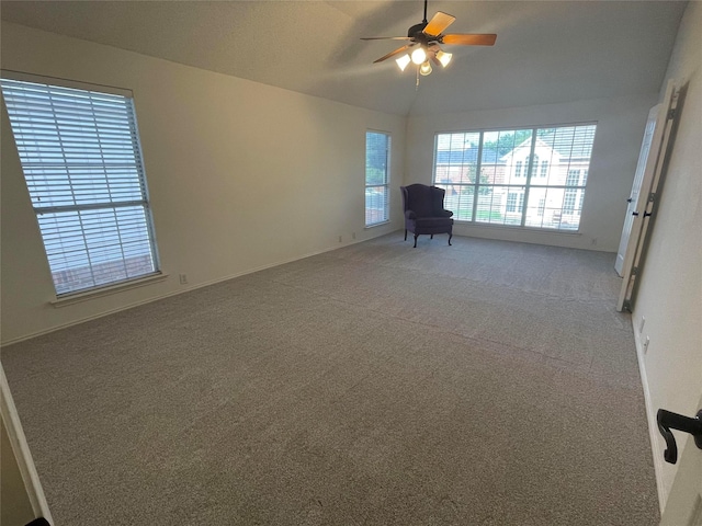 carpeted spare room with vaulted ceiling and ceiling fan