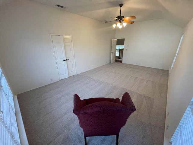 interior space featuring carpet floors, high vaulted ceiling, and ceiling fan