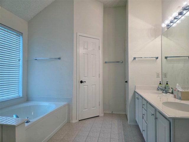 6464 Richmond Dr, Frisco, TX 75035 - bathroom with tile patterned flooring, double vanity, baseboards, a garden tub, and lofted ceiling