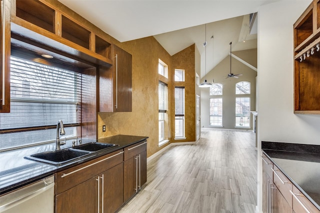 kitchen with sink, high vaulted ceiling, light wood-type flooring, dishwasher, and ceiling fan