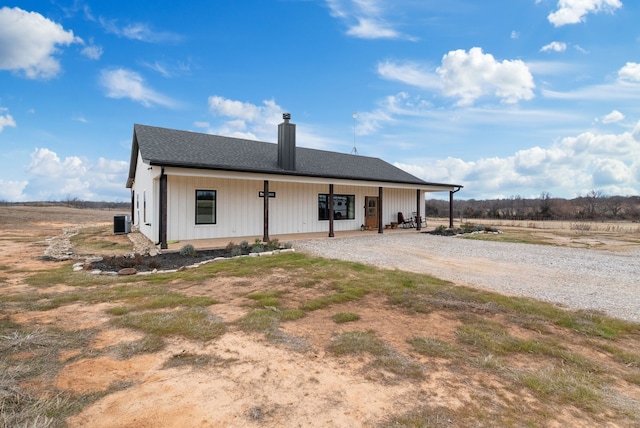 back of house with a porch and cooling unit