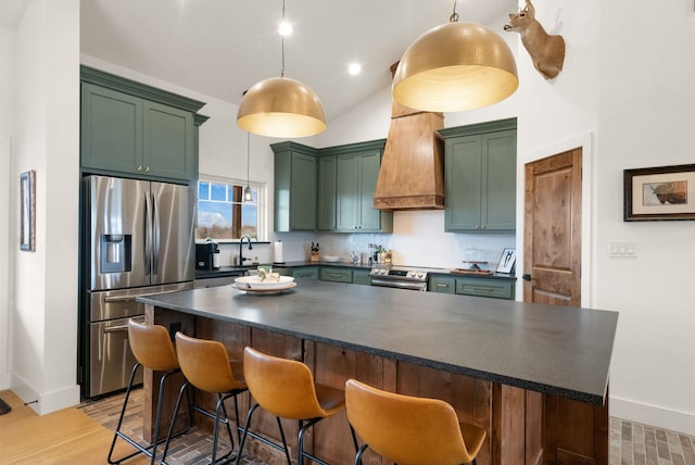 kitchen featuring premium range hood, tasteful backsplash, stainless steel appliances, and hanging light fixtures