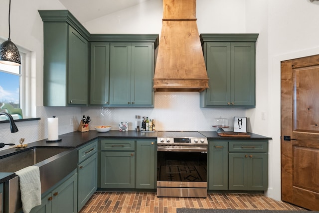 kitchen with sink, green cabinets, premium range hood, hanging light fixtures, and stainless steel electric stove