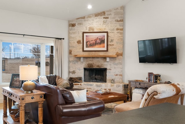 living room with lofted ceiling and a fireplace