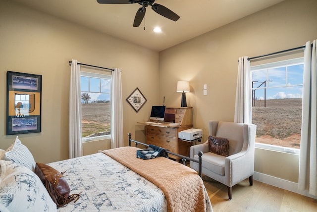 bedroom with light hardwood / wood-style flooring and ceiling fan