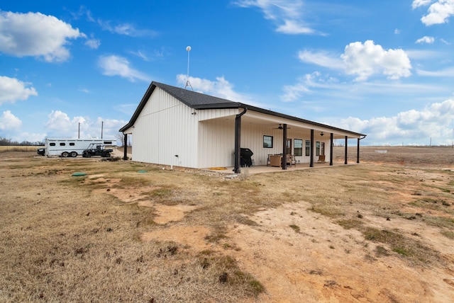 view of side of home featuring covered porch