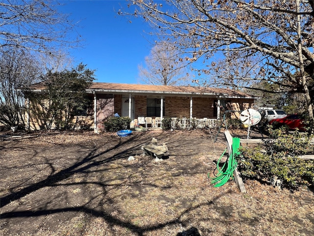 back of house featuring covered porch