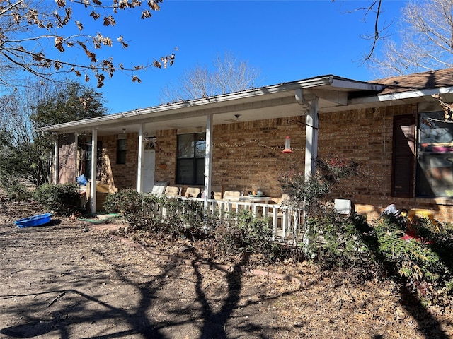 view of side of property featuring a porch