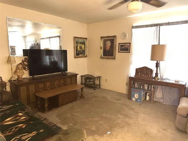 carpeted living room with ceiling fan and plenty of natural light