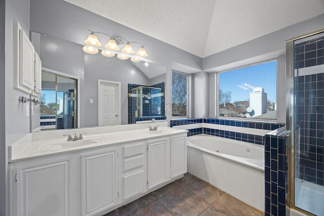 bathroom featuring vaulted ceiling, vanity, a textured ceiling, and plus walk in shower