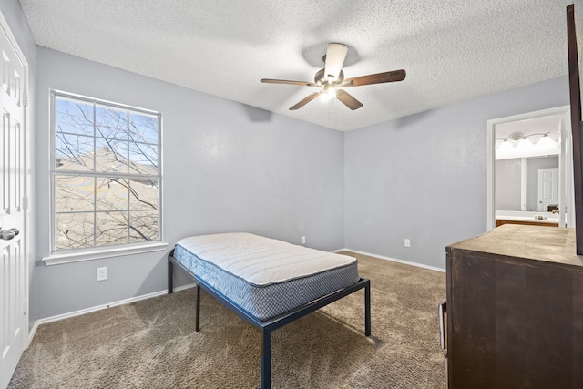 bedroom featuring ceiling fan, a textured ceiling, and dark colored carpet