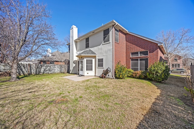 rear view of property with a patio area and a lawn