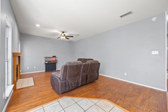 living room with ceiling fan and light wood-type flooring