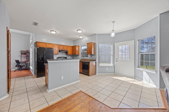 kitchen with light tile patterned flooring, sink, decorative light fixtures, a kitchen island, and black appliances