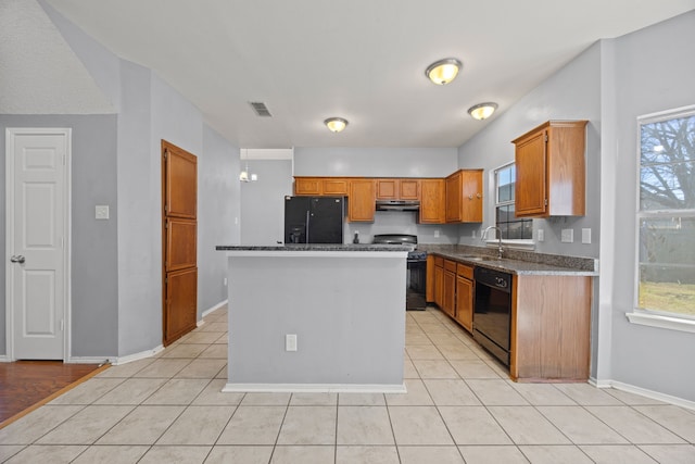 kitchen featuring sink, light tile patterned floors, plenty of natural light, a kitchen island, and black appliances