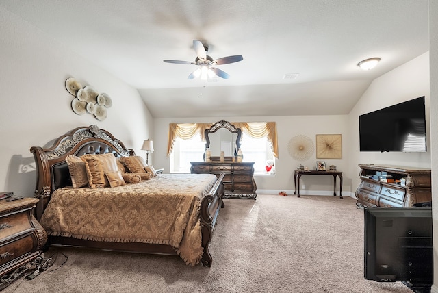 bedroom with ceiling fan, carpet flooring, and vaulted ceiling