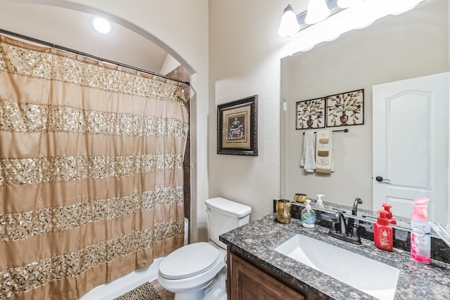 full bathroom featuring shower / tub combo with curtain, vanity, and toilet