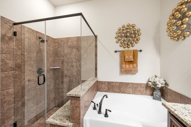 bathroom featuring vanity and separate shower and tub