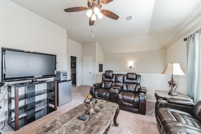 living room featuring ceiling fan, light colored carpet, and lofted ceiling