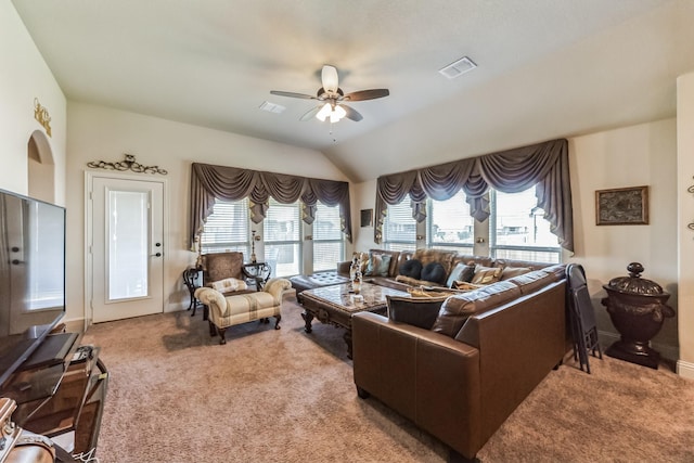 living room featuring ceiling fan, vaulted ceiling, a healthy amount of sunlight, and carpet flooring