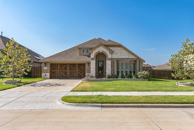 view of front facade with a garage and a front yard