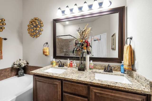 bathroom with vanity and independent shower and bath