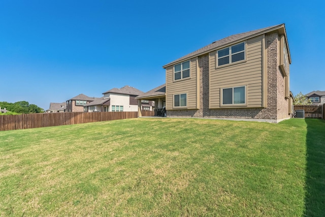 rear view of property featuring a lawn