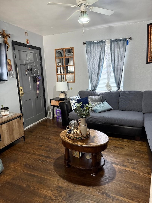 living room featuring dark hardwood / wood-style flooring and ceiling fan