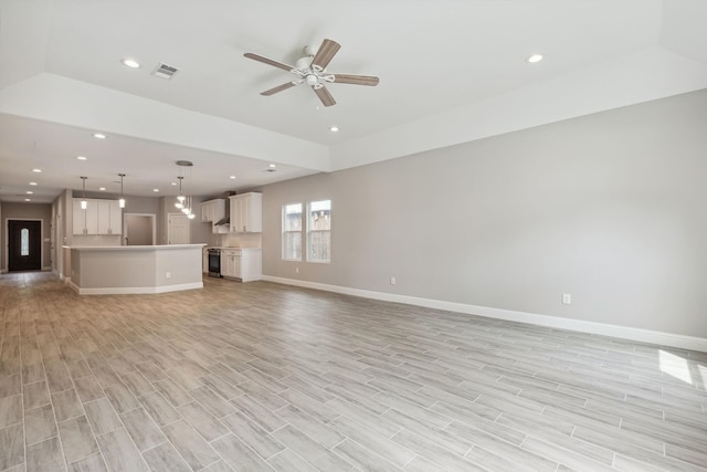 unfurnished living room featuring ceiling fan and light wood-type flooring