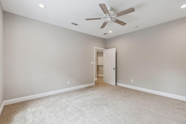 interior space with light carpet and ceiling fan