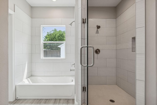 bathroom with separate shower and tub