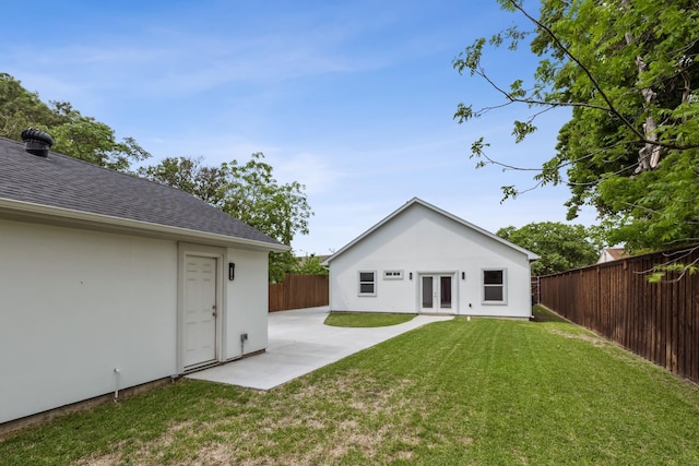 back of house with a yard, a patio area, and french doors