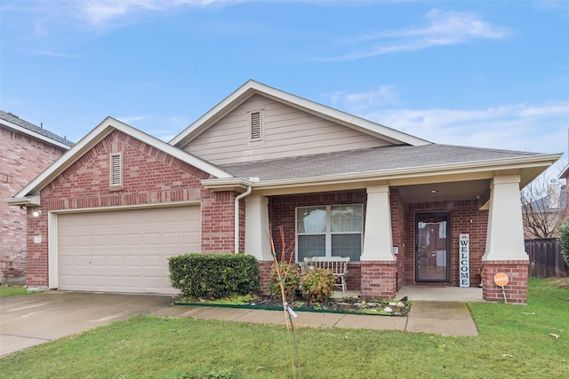 view of front of house with a garage, covered porch, and a front yard