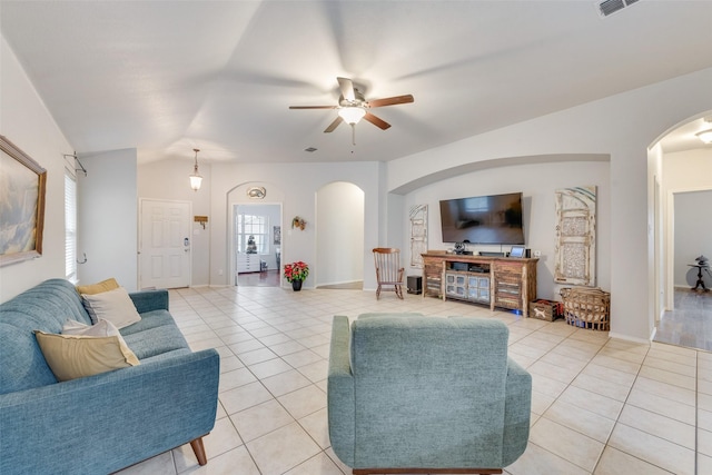 living room featuring vaulted ceiling, ceiling fan, and light tile patterned flooring