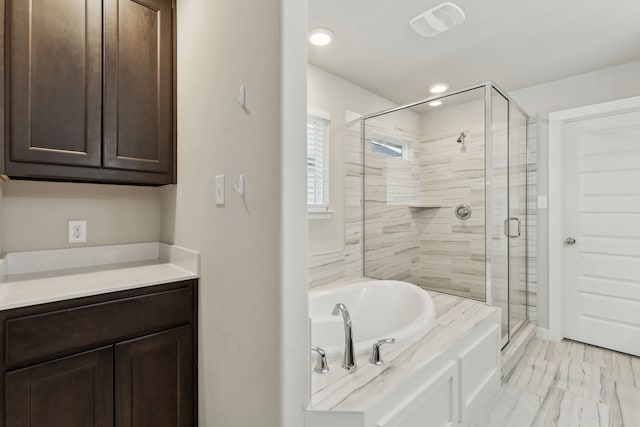 bathroom featuring shower with separate bathtub