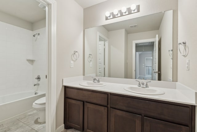 full bath with double vanity, toilet, visible vents, and a sink