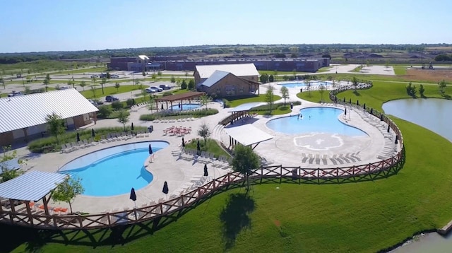 view of pool with a yard