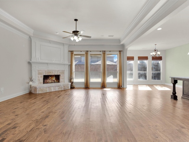 unfurnished living room featuring light hardwood / wood-style flooring, crown molding, and a fireplace