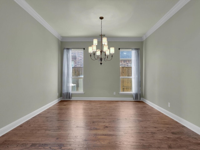 unfurnished dining area with ornamental molding, a healthy amount of sunlight, dark wood-type flooring, and a chandelier